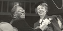 Mary McLeod Bethune pins a corsage on Eleanor Roosevelt. Mary McLeod Bethune pins a corsage on Eleanor Roosevelt.