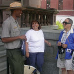 A park ranger chats with a couple of visitor in front of the national park visitor center.