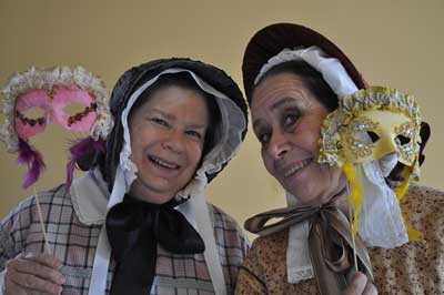 Our 1850s ladies in period dress show off their masks.