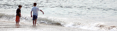 Two young boys enjoy the surf at Sand Beach.