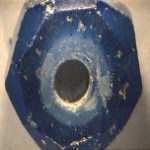 Blue bead made of ground glass.