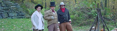 A volunteer and park rangers in costume