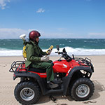 scientist on an ATV along a beachfront