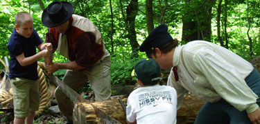 Rangers and school students log hewing