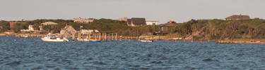 Private docks and small boats on bay side of Fire Island.