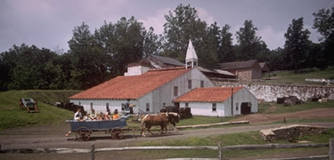 A wagon rumbles past the Cast House.