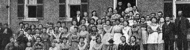 Photo of mill workers outside of a Boardinghouse