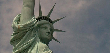 The iconic Lady Liberty watches over New York Harbor; visitors to the Statue of Liberty travel to Ellis Island on the same tour