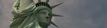 The iconic Lady Liberty watches over New York Harbor; visitors to the Statue of Liberty travel to Ellis Island on the same tour