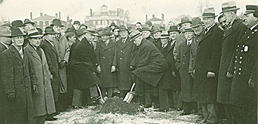 A group of men in overcoats and fedora hats take part in the groundbreaking for Salem Maritime NHS in 1937. NPS collections.