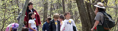 A ranger and students discuss habitats during an education program in the park.