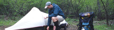 A camper sets up camp sets up his tent in Shenandoah's backcountry.