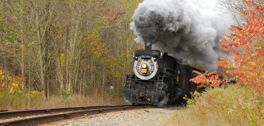 One of Steamtown's locomotives rolls through the late fall colors of the Pocono Mountains. (NPS Photo, Ken Ganz)