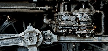 The air pump, which supplies compressed air for the brakes, sits above the main drive rods. NPS Photo, Ken Ganz
