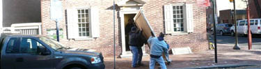Photo of men carrying display