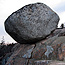 Rock sit precariously on cliff.