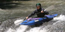 Kayak running small drop on the river