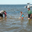 Ranger and group in water with seine net.