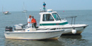 Two boats side-by-side on the water.