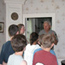 Small group of students listen intently to park ranger conducting tour inside William Floyd Estate house.