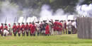 Group of British soldiers firing muskets at Fort Necessity