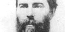 Herman Melville, his picture is black and white, he has a big bushy beard.