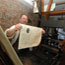 Ranger showing printed paper on repro 18th century printing press
