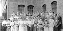 Photo of mill workers outside of a Boardinghouse