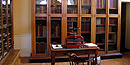 The tall glass fronted bookcase in the Customs House once held leather bound volumes.