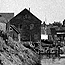 historic photo of a two and a half story building on a harbor
