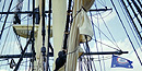 A view of the rigging of Friendship, looking up through the spiderweb of lines attached to the horizontal yards and vertical masts.