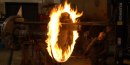 A ring of flame envelopes a steam locomotive drive wheel as a tire is heated so it can be placed on the wheel.