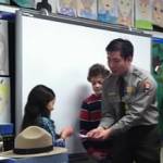 Park ranger works with elementary school students in classroom