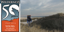 1964-2014 Wilderness 50th Anniversary logo beside winter backpacker on Fire Island 1964-2014 Wilderness 50th Anniversary logo beside winter backpacker on Fire Island