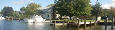 Park headquarters building and boat on river.