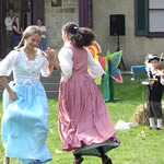 Children in historic clothing dancing on the Gallatin House lawn