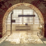 An arched cell door inside Castle Williams