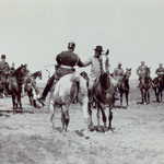 President Roosevelt greets Kaiser Wilhelm on horseback.