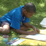 A young visitor enjoys painting with watercolors.