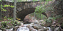 Cobblestone Bridge, faced with rounded cobblestones, has a stream running underneath. Cobblestone Bridge, faced with rounded cobblestones, has a stream running underneath.