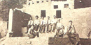 In this sepia-toned photo from 1927, nine men sit and kneel amongst the ruins of a Native American dwelling at Mesa Verde. NPS Photo. In this sepia-toned photo from 1927, nine men sit and kneel amongst the ruins of a Native American dwelling at Mesa Verde. NPS Photo.