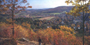 View of Woodstock village from Mount Tom's South Peak; the village and person in foreground are framed by autumn foliage. NPS Photo. View of Woodstock village from Mount Tom's South Peak; the village and person in foreground are framed by autumn foliage. NPS Photo.
