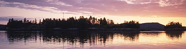 Saint Croix Island is reflected in the Saint Croix River at sunrise. Photo by Sara Grey.