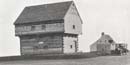 Grayscale picture of the Blockhouse. The Neilson House is visible to the right and rear. Grayscale picture of the Blockhouse. The Neilson House is visible to the right and rear.
