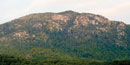 The huge gray granite boulders rise above the green ridges of Old Rag Mountain. The huge gray granite boulders rise above the green ridges of Old Rag Mountain.