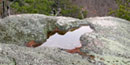 Water stands in a pit, called an Opferkessel, in a boulder on Old Rag Mountain. Water stands in a pit, called an Opferkessel, in a boulder on Old Rag Mountain.