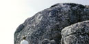 A hiker is dwarfed by the huge, round, lichen-covered boulders of Old Rag Mountain. A hiker is dwarfed by the huge, round, lichen-covered boulders of Old Rag Mountain.