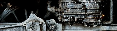 The air pump, which supplies compressed air for the brakes, sits just above the rods on the side of a locomotive.  NPS Photo, Ken Ganz