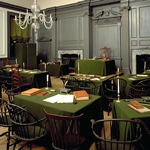 Assembly Room, showing Windsor chairs around tables covered with green baize cloth.