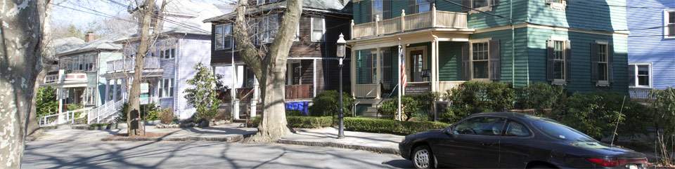 A photograph of the front of the John Fitzgerald Kennedy birthplace and surrounding houses on Beals Street